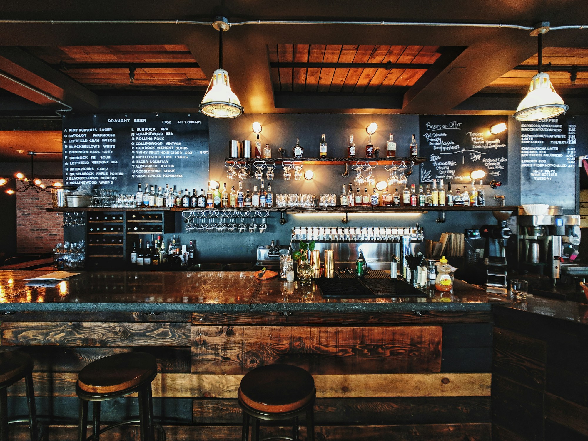 An inviting timber bar beneath warm pendant lights